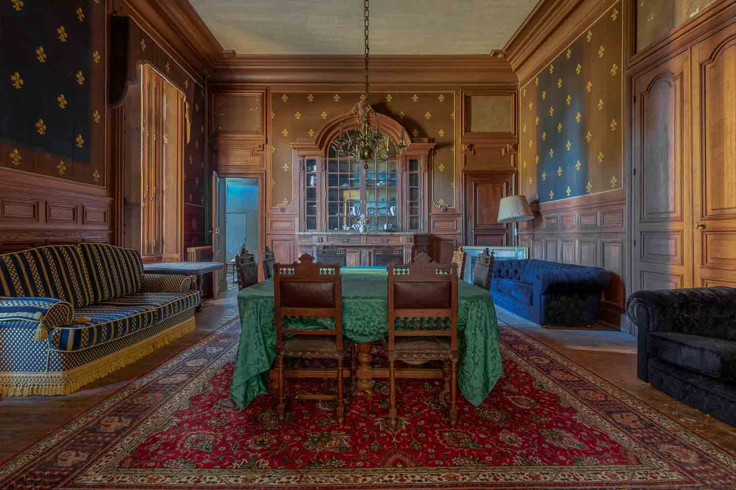 Luxurious dining room in Chateau de la Rivière featuring ornate decor and garden vistas.